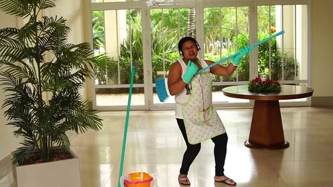 Funny Housekeeper Dancing and Having Fun With Broom Stock Footage 83391528