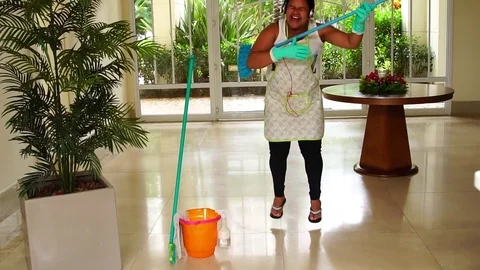 Funny Housekeeper Dancing and Having Fun With Broom Stock Footage 83391661
