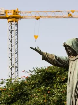 Funny image of a statue catching crane hook Stock Photos