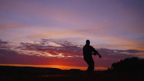 Funny karate kid practicing martial arts on sunset background Stock Footage 221187503