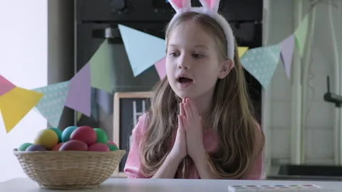 Funny kid with bunny ears play Easter hare hunter at home Video stock 265117189