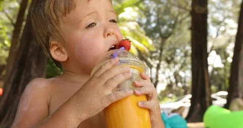 Funny kid drinking fruit fresh in tropics Stock Footage 101569808