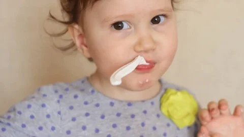Funny kid eats food with a spoon. Stock Footage 73918061