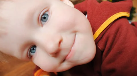 Funny kid looks into the camera Stock Footage 24692066