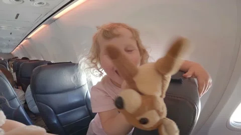 Funny kids fooling at airplane cabin flying to family travel summer vacation Stock Footage 202273651