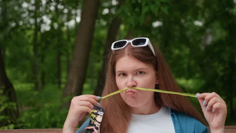Funny Lady Making Mustache Face with Thread While Turning Eyes Outdoors Stock Footage 322667426