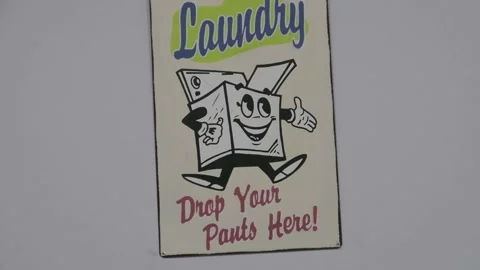 Funny laundry room drop your pants here graphic sign zoom out Stock Footage