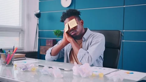 Funny lazy office worker napping at workplace covering eyes with sticky notes Video stock 163300766
