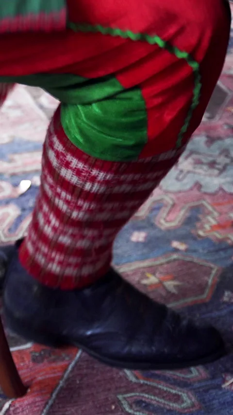 Funny legs dancing under the table. Male's legs in colorful fairy clothing Stock Footage 289543770