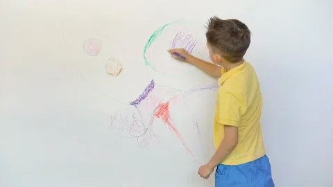 Funny little boy drawing rocket on white background Stock Footage 114738226