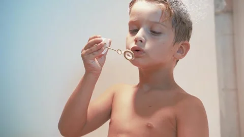 Funny little boy five year old sitting in the bathtub Stock Footage 255686687