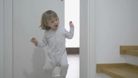 Funny little child open and shut the door, play, smile laughing, hide and seek Stock Footage 157061237