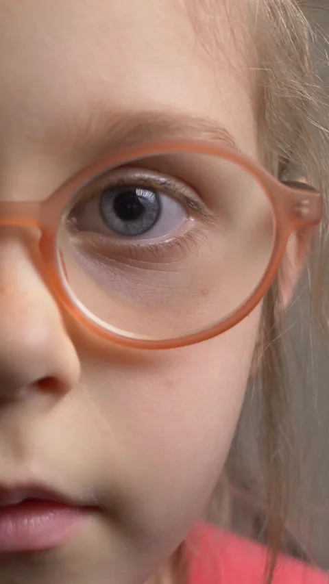 Funny little girl in glasses with eye Stock Video Pond5