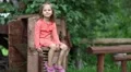 Funny little girl sits on the chair with spring HD Footage