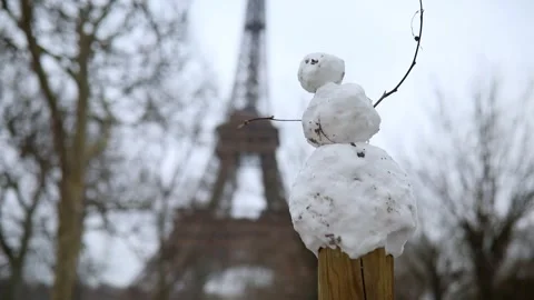Funny little snowman and the Eiffel tower on a day with heavy snow Stock Footage 317102778