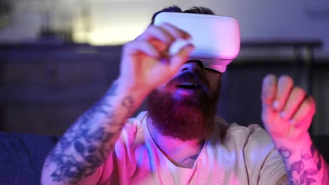 Funny looking bearded man playing in video games with vr headset. Stock Footage 122592813