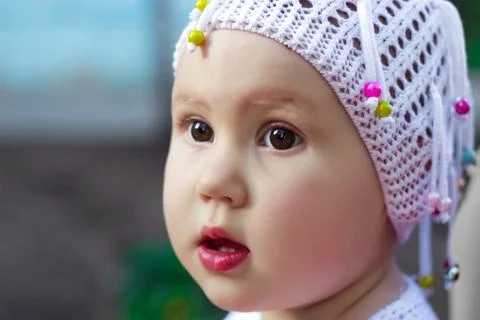 Funny looking girl with big brown eyes. Portrait child close up. Stock Photos
