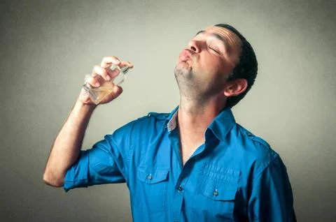 Funny man applying perfume Stock Photos