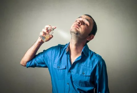 Funny man applying perfume Foto stock