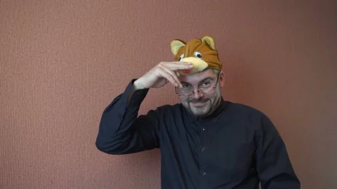 A funny man with a bear hat on his head 4K Video stock 87809955