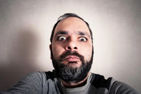 Funny man with the beard making expressions Stock Photos