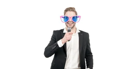 Funny man in business formalwear and party glasses hold microphone happy smiling Stock Photos
