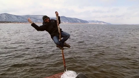 Funny man climbed up the pole Stock Footage 74160981