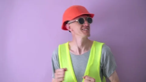 Funny man in construction uniform is dancing. Stock Footage 109421199
