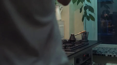 Funny man cooking meal pulling out belly, smacks it at kitchen Stock Footage 83089796