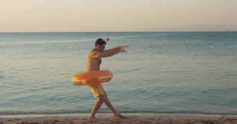 Funny man dancing on the beach Stock Footage 64773811