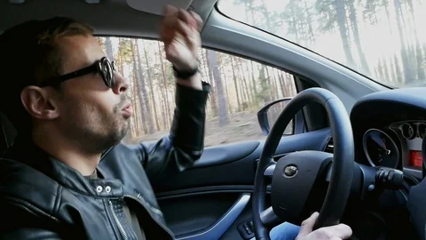 Funny man dancing in car while driving in slow motion Stock Footage 107989051