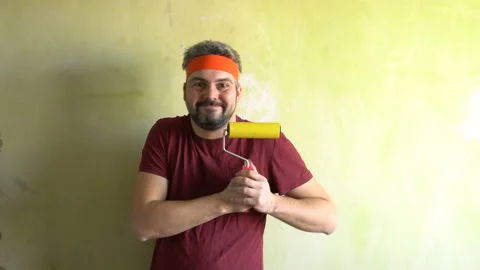 Funny man dancing with a wallpaper roll 4K Stock Footage 126126008