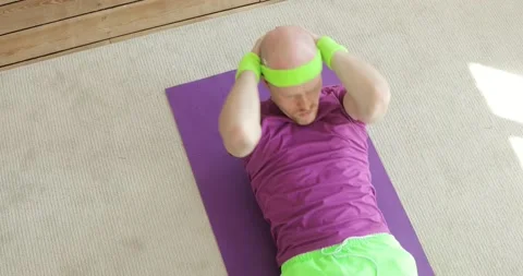 Funny man is doing abs exercises crunches at home on floor, sportive humor. Stock Footage 131068209