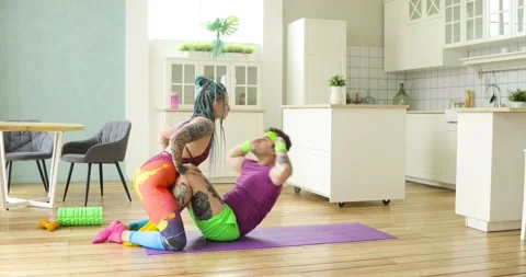Funny man doing abs exercises crunches with wife kissing her, fitness humor. Stock Footage 132484621