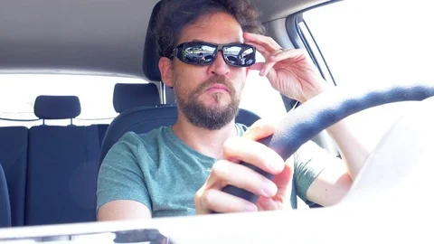 Funny man driving car with two sunglasses Stock Footage 77576367