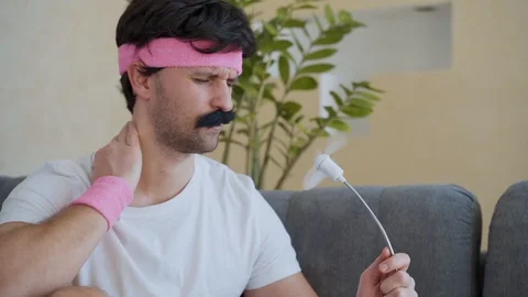 Funny man feeling hot in front of a fan Stock-Footage 129252542