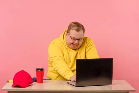 Funny man geek using laptop with comical foolish grimace Stock Photos