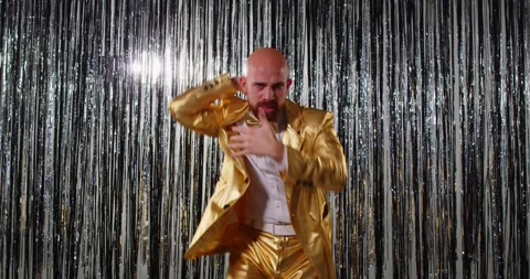 Funny man in golden suit, dancing carefree to music, having fun and entertains Stock Footage 312897284