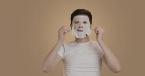 Funny man having fun at home applying face mask for better mood, feeling great Stock Footage 222004901