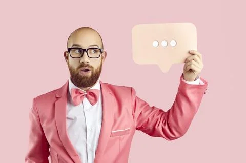 Funny man holding message bubble with three dots showing that someone is typing Foto stock