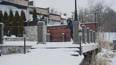 Funny man pulling a sled then turning over it for laugh of friends Stock-Footage 117071810