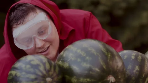 Funny Man with safety goggles preparing to slice some watermelons Stock Footage 258316346