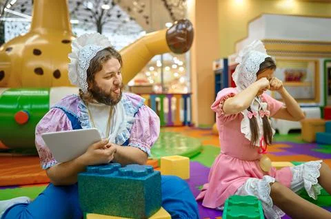 Funny man snatching digital tablet from woman, people babies Stock Photos