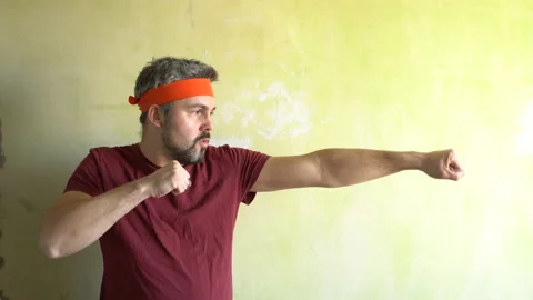 Funny man is training against the wall 4K Stock-Footage 126126076