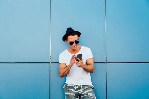 Funny man using a mobile phone outdoors. Stock Photos