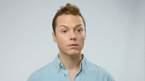 Funny man watching something, moving around the camera Видео 42237128