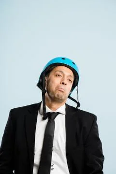 Funny man wearing cycling helmet portrait real people high definition blue ba Stock Photos