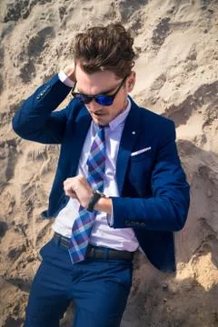Funny manager lost in time and is late on the work. Serious young man Stock Photos