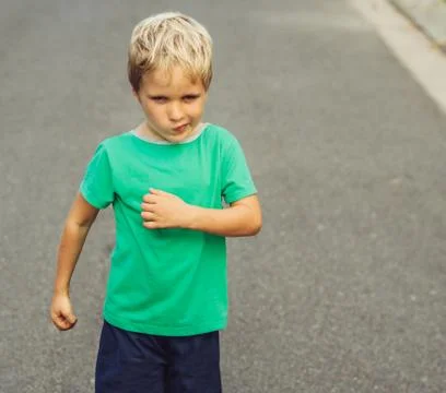 Funny mischievous blond boy making freckled face, artistic emotions and Stock Photos