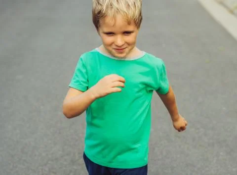 Funny mischievous blond boy making freckled face, artistic emotions and Stock Photos